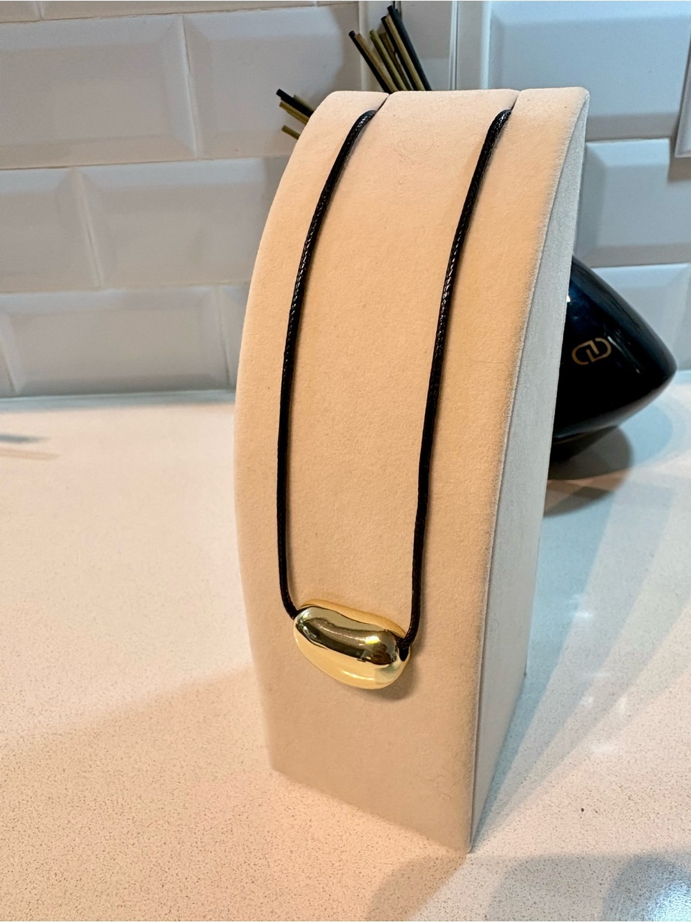 Gold Tone Bean Pendant Necklace on Black Cord